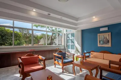 a living room with a couch and chairs at Hermes Hotel in Kissamos