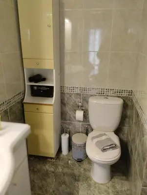 a bathroom with a white toilet and a sink at EMMY APARTMENT in Chania Town