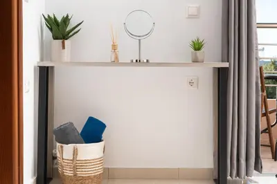 a shelf with plants and a mirror in a room at The Cozy Nook in Chorafakia