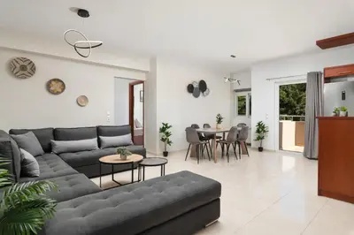 a living room with a couch and a table at The Cozy Nook in Chorafakia