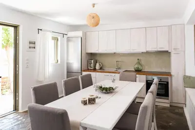 a kitchen with a white table and chairs at Villa Olvía in Sfakiá