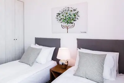 a bedroom with two beds and a table with a lamp at Villa Olvía in Sfakiá
