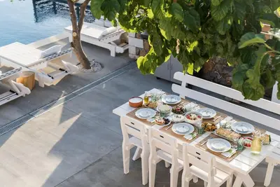 a table with food on it on a patio at Villa Olvía in Sfakiá