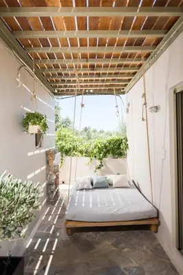 a porch with a swinging bed in a room at Villa Olvía in Sfakiá