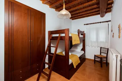 a room with a bunk bed and a cabinet at Falasarna's Sunset Home in Falasarna