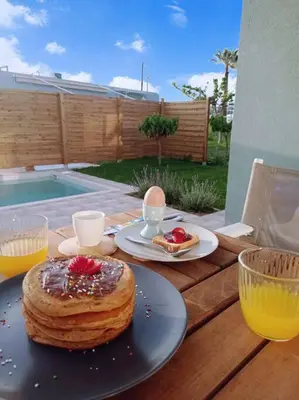 a wooden table with a cake and drinks on it at Nostalgico cottage in Chania Town
