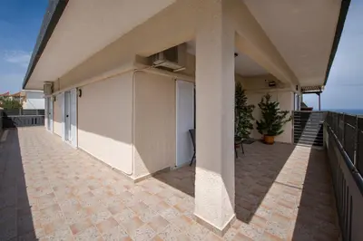 a large balcony of a house with a patio at Marakas Winery Family House in Xamoudhokhórion