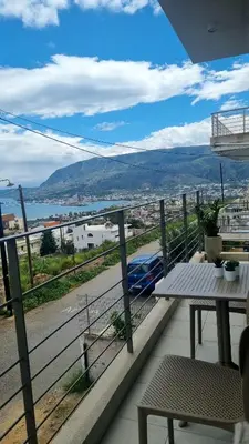 a balcony with a table and a view of a city at Marigold Apartments in Chania Town