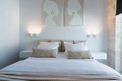 a bedroom with a large white bed with white pillows at Perla Dream Luxury Villa in Chania Town