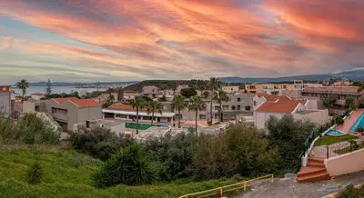 a group of houses in a city under a cloudy sky at Perla Dream Luxury Villa in Chania Town