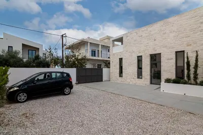 a black car parked in front of a house at Perla Dream Luxury Villa in Chania Town
