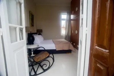 a small bedroom with a bed and a window at Tatiana's Garden House in Chania Town