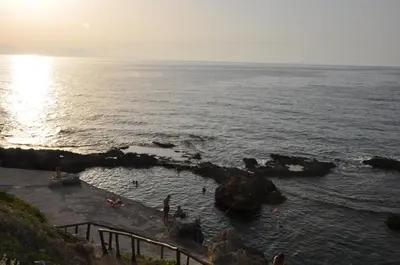 a group of people in the water at the beach at Mirma Halepa superior studio in Chania Town