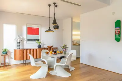 a dining room with a white table and chairs at Artful City Loft with Rooftop Terrace, Near Beach in Chania Town