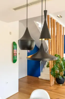 two metal pendant lights hanging in a living room at Artful City Loft with Rooftop Terrace, Near Beach in Chania Town