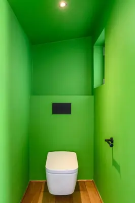 a green bathroom with a toilet in a green wall at Artful City Loft with Rooftop Terrace, Near Beach in Chania Town