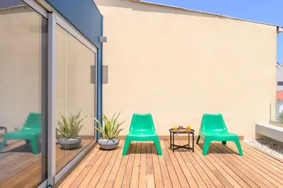 three green chairs and a table on a deck at Artful City Loft with Rooftop Terrace, Near Beach in Chania Town