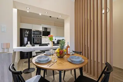 a dining room and kitchen with a table and chairs at Georginas home in city center in Chania Town