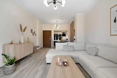a living room with a white couch and a table at Georginas home in city center in Chania Town