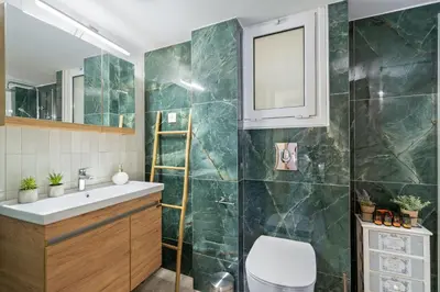 a bathroom with a toilet and a sink and a mirror at Georginas home in city center in Chania Town