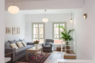 a living room with a couch and a chair at House of Sirri in Chania Town