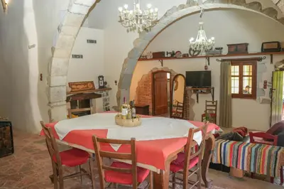 a dining room with a table and chairs at Traditional Villa with pool in Sfakia in Ímbros