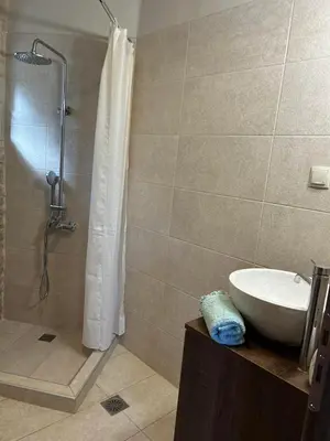 a bathroom with a shower and a sink and a shower at Fanouria's home in Kalleryianá