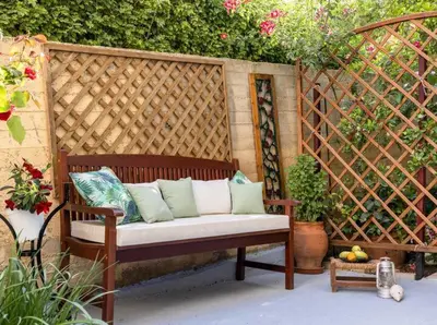 a wooden bench with pillows on a patio at Eva Cozy Apartment in Chania Town
