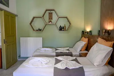 two beds in a room with two mirrors at Kydonia apartments in Plataniás