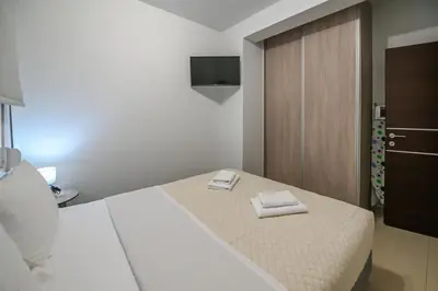 a bedroom with a bed with two towels on it at A & G Apartments in Kolymvari