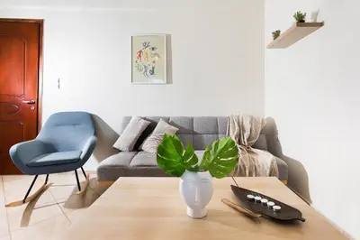 a living room with a couch and a vase on a table at Kds Overlooking Chania in Chania Town