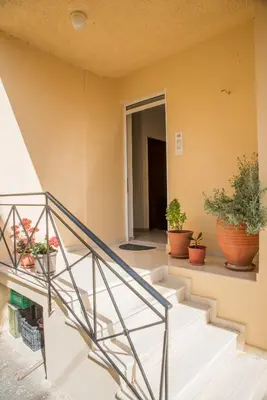 a staircase in a house with potted plants at Kds Overlooking Chania in Chania Town