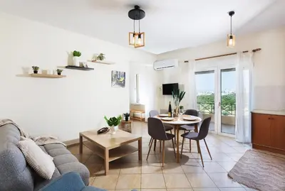 a living room with a couch and a table at Kds Overlooking Chania in Chania Town
