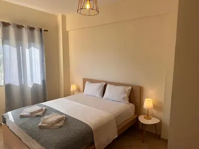 a bedroom with a bed with two towels on it at Kds Overlooking Chania in Chania Town