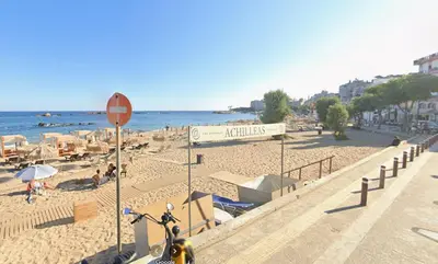 a bike parked next to a beach with chairs and umbrellas at Sun Beach Apartments in Chania 09 11 in Chania Town