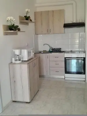 a kitchen with a white stove and a microwave at Sun Beach Apartments in Chania 09 11 in Chania Town