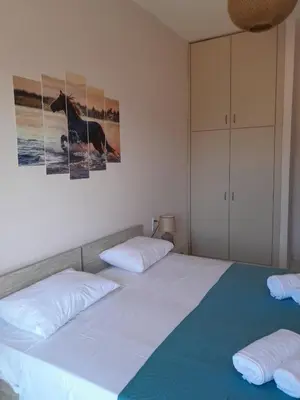 a bedroom with two beds and a picture of a dog at Sun Beach Apartments in Chania 09 11 in Chania Town