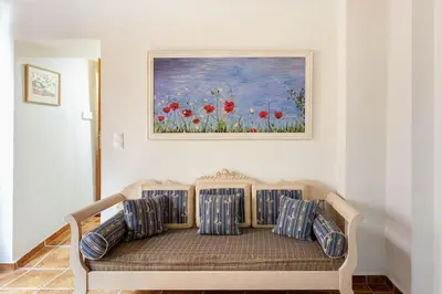 a couch in a room with a painting on the wall at Cozy house in the old town in Chania Town
