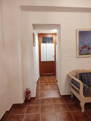 a hallway with a door and a tiled floor at Cozy house in the old town in Chania Town