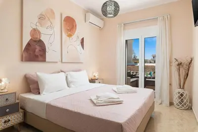 a bedroom with a large bed and a balcony at Harmony Apartment in Chania in Chania Town