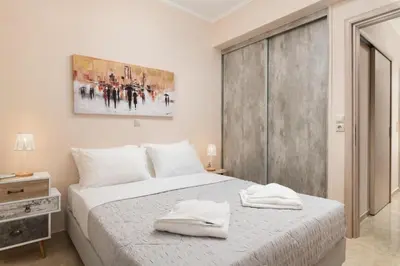 a bedroom with a bed with two towels on it at Harmony Apartment in Chania in Chania Town