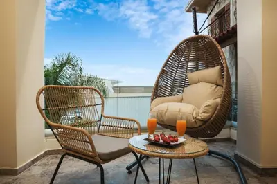 a patio with two chairs and a table and a chair at Harmony Apartment in Chania in Chania Town