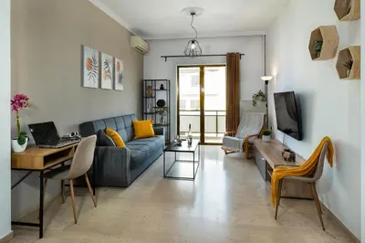 a living room with a couch and a table at Central apt. with parking - 3 min from old port in Chania Town