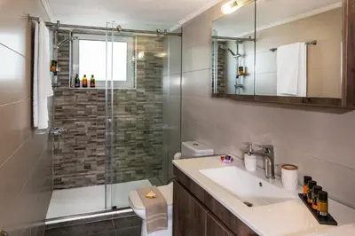 a bathroom with a sink and a shower at Central apt. with parking - 3 min from old port in Chania Town