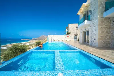a villa with a swimming pool with a view of the ocean at Nafsika Xenia - Alkinoos Villa in Plátanos