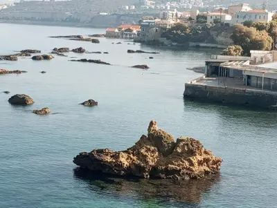 a view of a body of water with rocks in it at Sunny family apartment in Chania close to the sea in Chania Town