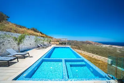 a swimming pool with a view of the ocean at Nafsika Xenia - Ariti Villa in Plátanos