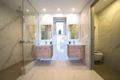 a bathroom with two sinks and a shower at Nafsika Xenia - Ariti Villa in Plátanos