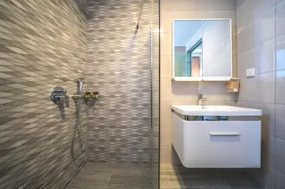 a bathroom with a shower with a sink and a mirror at Nafsika Xenia - Ariti Villa in Plátanos