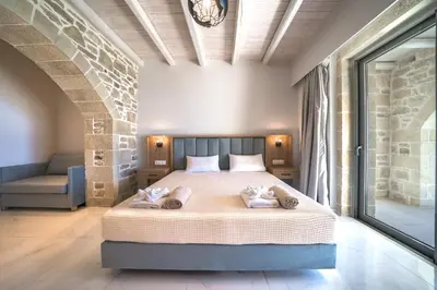 a bedroom with a bed with two towels on it at Nafsika Xenia - Ariti Villa in Plátanos